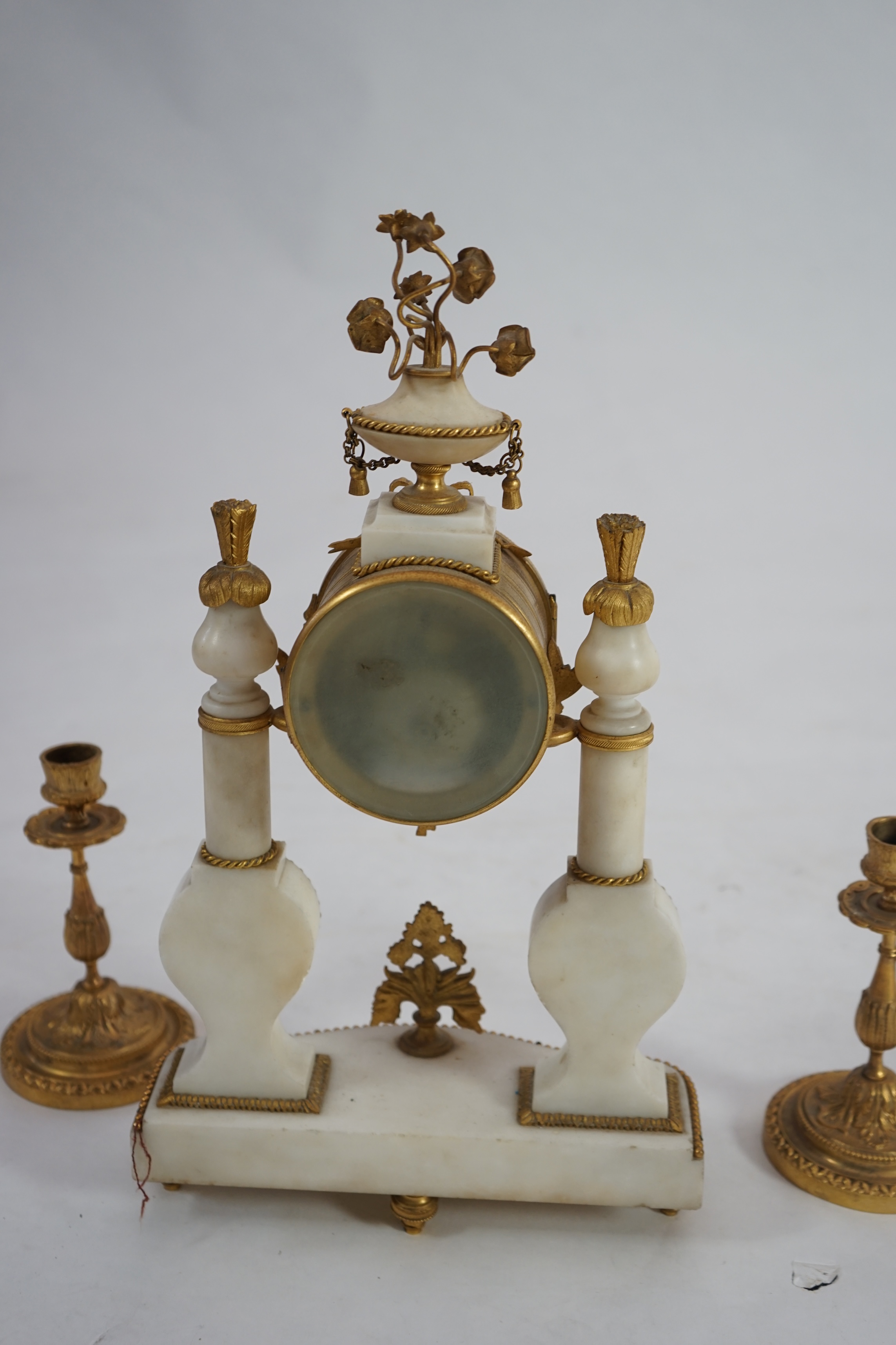 An early 20th century French ormolu mounted white mounted portico clock